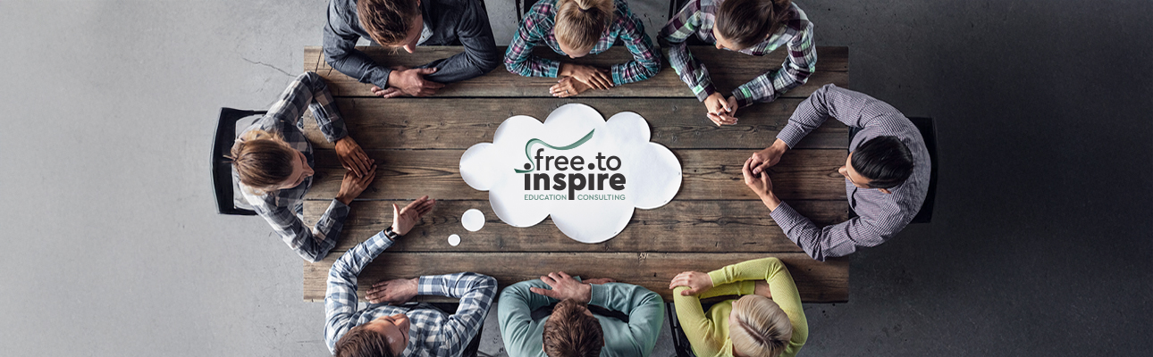 Hipster business teamwork brainstorming planning meeting concept, people sitting around the table with white paper shaped like dialog cloud